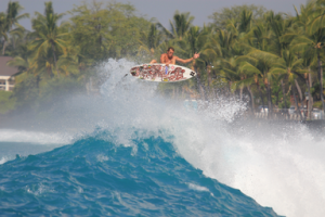 Image of a surfer catching air on a wave.