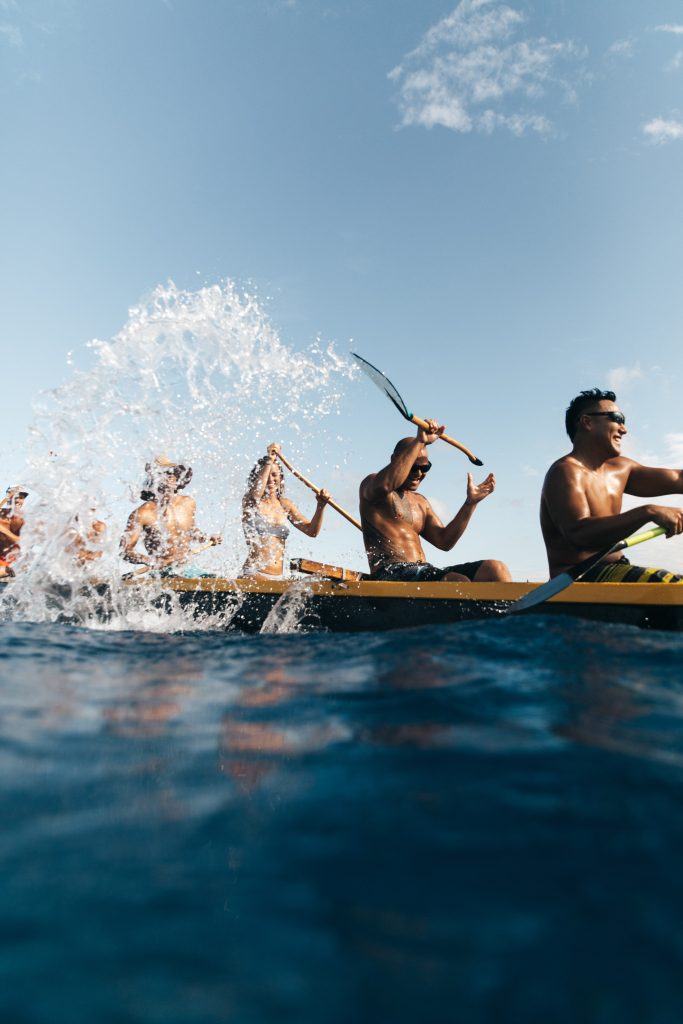 Group paddles canoe along Kailua-Kona coast