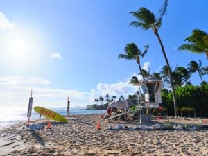 Image of a lifeguard stand on the beach on a sunny day.
