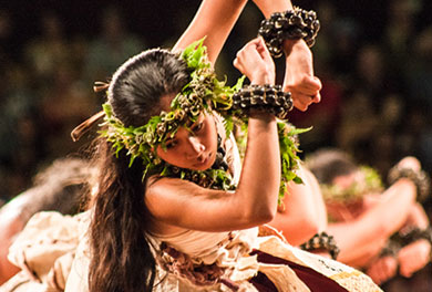 A woman performing a hula kahiko, an ancient, spiritual Hawaiian dance style performed to traditional chants (oli). 
