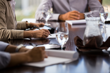 Business workers sitting at a conference table. 