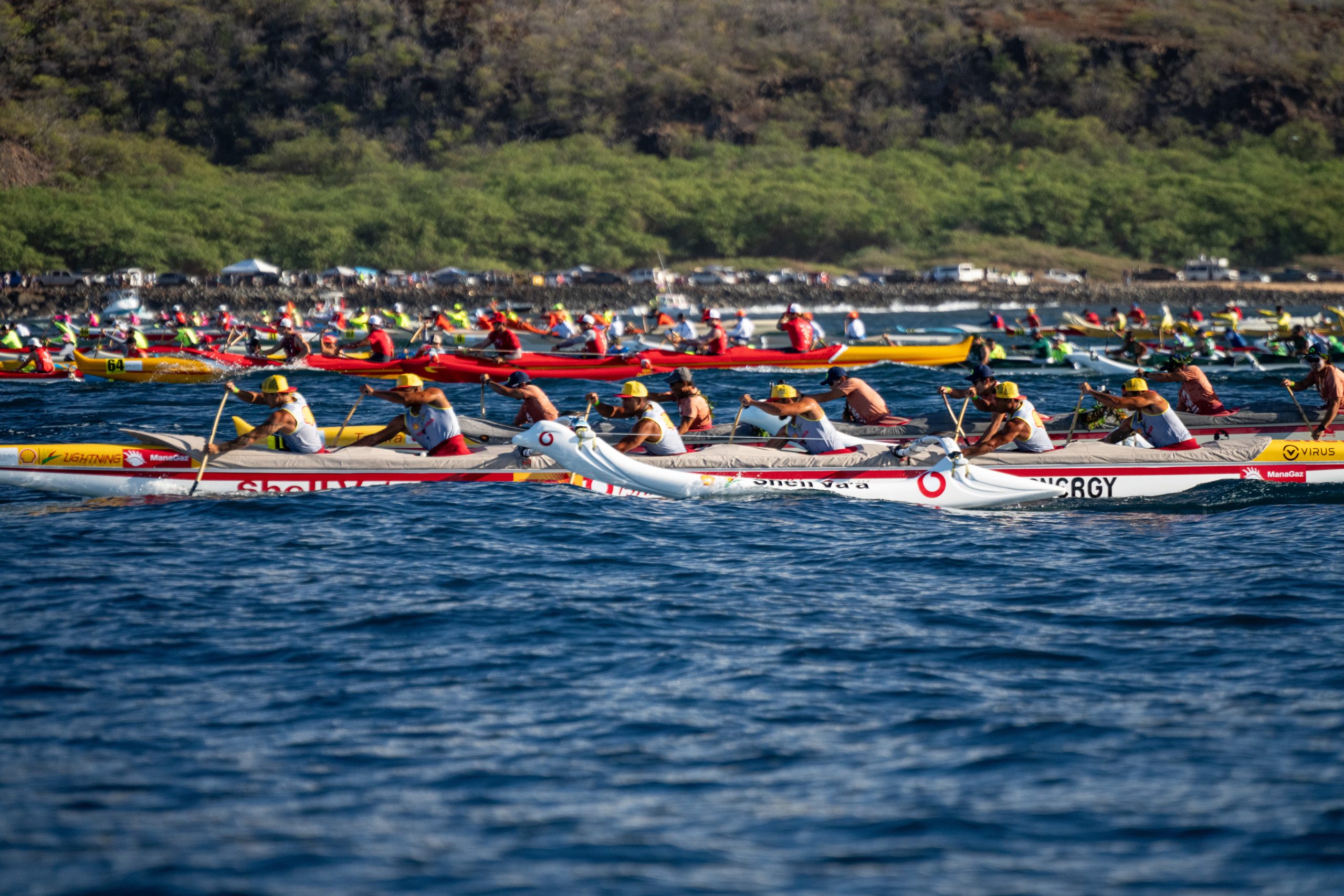 Image of canoes racing in the open ocean. 