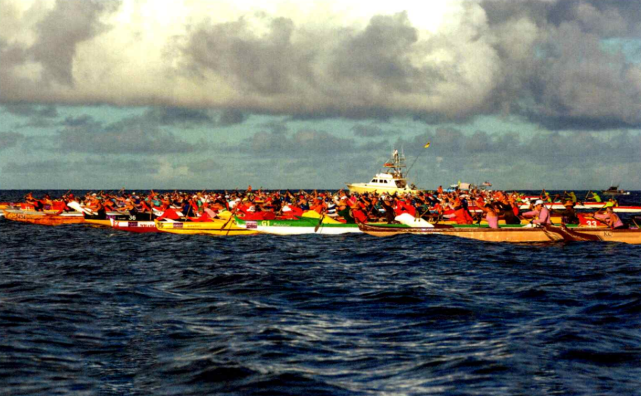Image of a canoe race in the open ocean. 